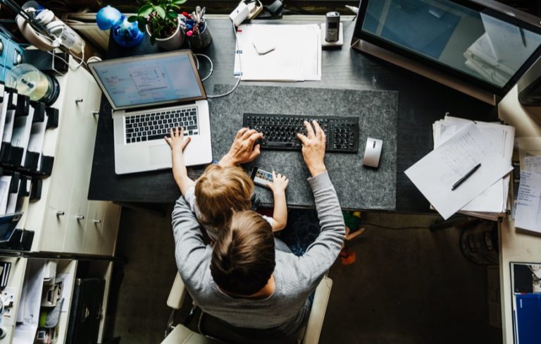 man and child at two computers remote work