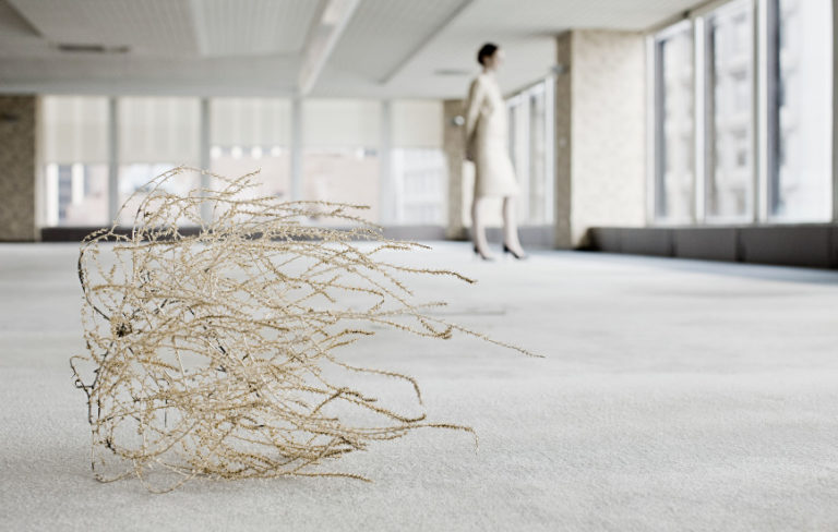 tumbleweed in empty office with one person illustrating great resignation