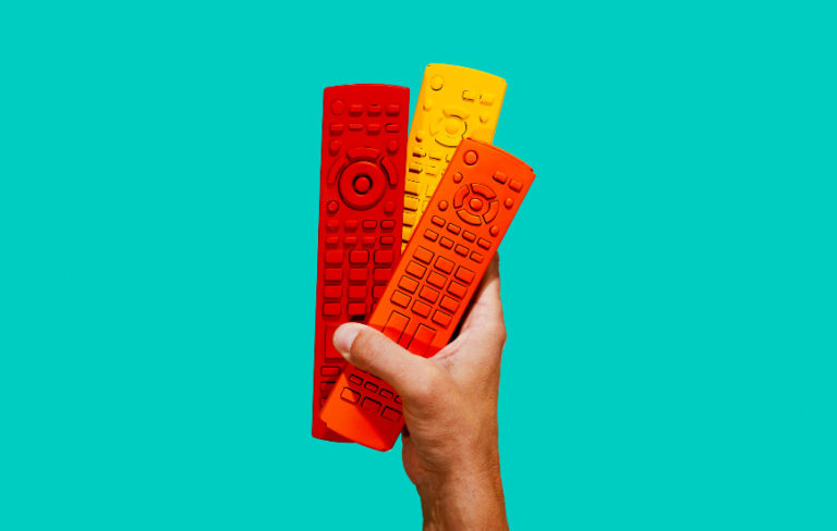 hand holding red yellow and orange remotes - remote work for contractors