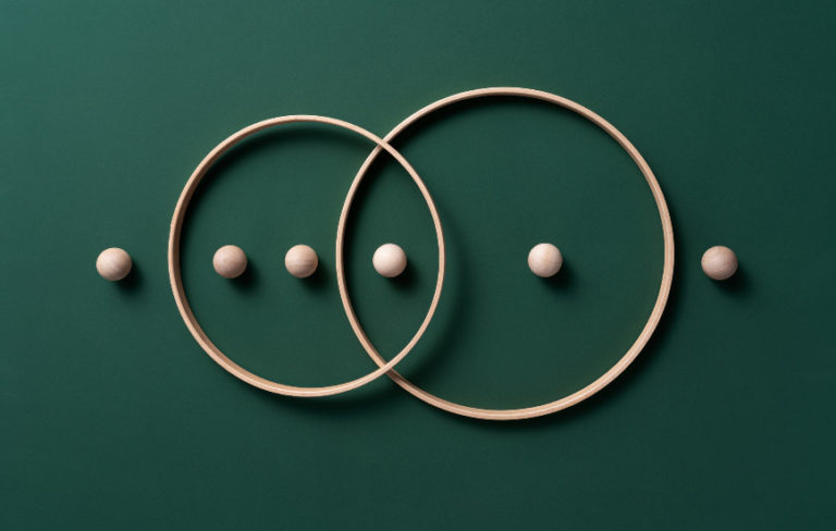 2 overlapping wood rings with wood balls inside different sections